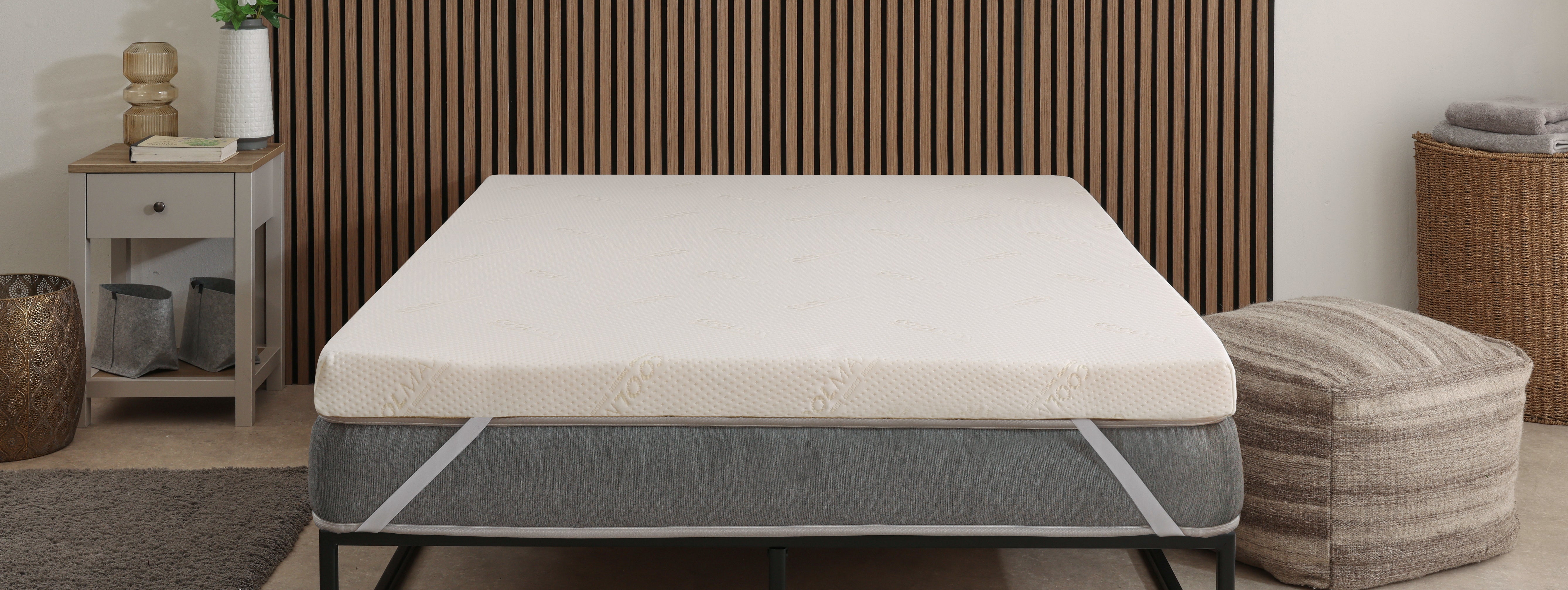mattress topper on a bed in a lifestyle view